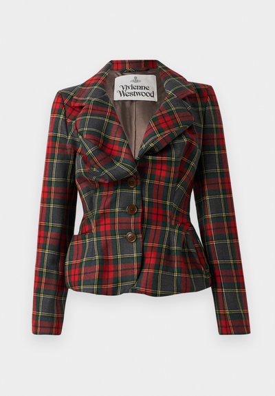 Punainen ja musta ruudullinen takki, jossa on istuva malli, suuret läpät ja kolme ruskeaa nappia edessä. Vuorattu sisäosa, Vivienne Westwood -logo näkyvissä.