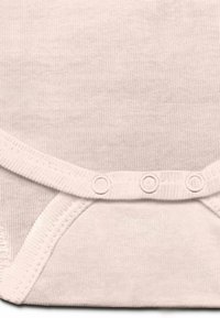 Pale pink cotton baby bodysuit with a ribbed texture, featuring snap buttons along the bottom and soft curved edges.