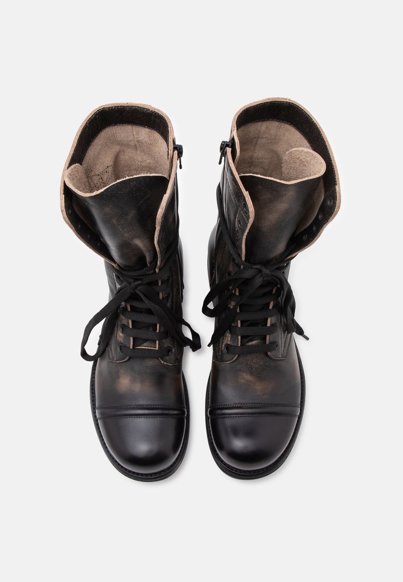 Pair of black leather lace-up boots with padded tongues folded outward, displayed on a white background.