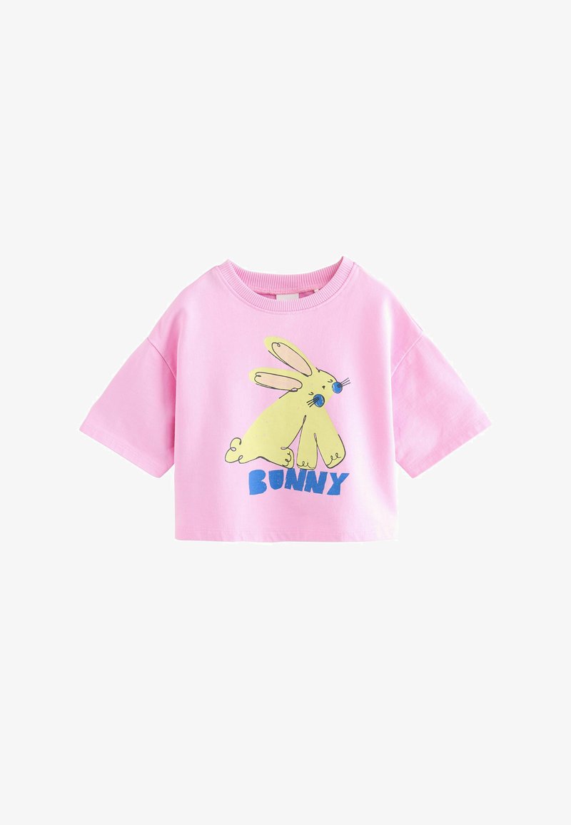 Pink short-sleeve cropped T-shirt with a yellow cartoon bunny and the word "Bunny" in blue letters on the front.