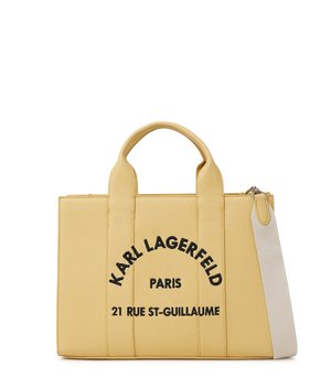 Żółta teksturowana torba typu tote z dwoma uchwytami, białym paskiem na ramię i czarnym napisem "Karl Lagerfeld Paris 21 Rue St-Guillaume" na przodzie.