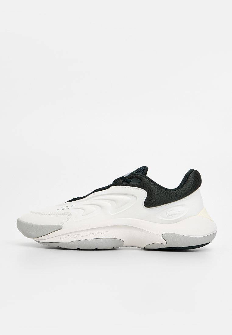 Lacoste sneakers with a white and black design, textured rubber sole, and smooth upper. Features lace-up closure and logo detailing.