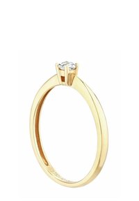 Kultasormus, jossa on yksinkertainen rengas, jossa on pyöreä kirkas kivi asetettuna kuuden piikin pidikkeeseen, kiillotettu sileäksi ja kiiltäväksi.