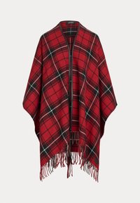 Poncho a scacchi rossi con orlo frangiato, davanti aperto con zip e dettagli in bianco e nero nel motivo a quadri. Realizzato in tessuto morbido.