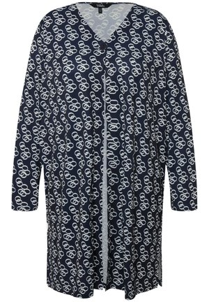 Marineblauwe lange cardigan met een wit cirkelvormig patroon, V-hals en enkele knoopsluiting. Gemaakt van zachte, lichte stof.