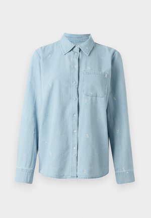 Light blue denim shirt with long sleeves, button front, and a chest pocket. Features white floral embroidery across the fabric.