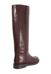 Burgundy leather knee-high boot with a smooth finish, rounded toe, and low stacked heel. Features subtle stitching and minimal hardware.