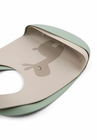 Silikoonist bib, millel on ümar kaelus. Hele roheline äär ja beež keskosa, millel on koomilise loomade disain. Sile tekstuur, paindlik struktuur.