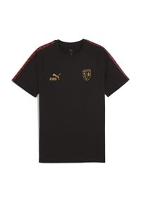 Černé tričko s krátkým rukávem vyrobené z bavlny. Obsahuje červené vzorované akcenty na ramenou, zlaté logo "KING" a znak klubu na hrudi.