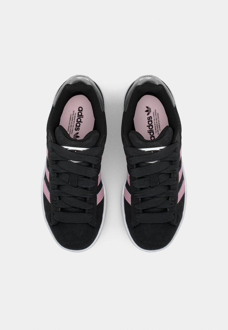 Sneaker nere in suede con strisce rosa, lacciate, caratterizzate da una superficie testurizzata e una suola bianca. Il marchio è visibile sulla linguetta.