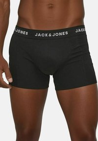 Schwarze Boxer Shorts aus dehnbarem Material mit einem breiten Bund, der mit dem weißen Branding "JACK & JONES" versehen ist, und flachen Nähten für zusätzlichen Komfort.