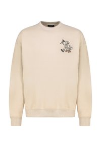 Beiger Pullover mit rundem Ausschnitt und langen Ärmeln. Mit einer schwarzen Cartoon-Grafik auf der linken Brust. Hergestellt aus weichem Stoff.