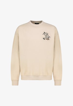 Beiger Pullover mit rundem Ausschnitt und langen Ärmeln. Mit einer schwarzen Cartoon-Grafik auf der linken Brust. Hergestellt aus weichem Stoff.