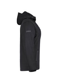 Giacca nera con cappuccio caratterizzata da una tasca con cerniera, tessuto testurizzato e la parola "JAKO" stampata sulla manica. Silhouette liscia e polsini.