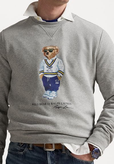 Gray sweatshirt featuring an embroidered bear in sunglasses wearing a white and blue jersey with "RLTC" and navy joggers.
