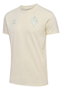 Cremefarvet bomulds T-shirt med rund halsudskæring, korte ærmer og et lys grønt diamantlogo på brystet. Glat tekstur.