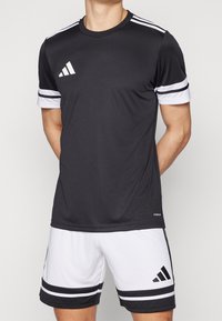 Black athletic shirt with white accents, featuring a round neckline, short sleeves, and three white stripes on each sleeve.