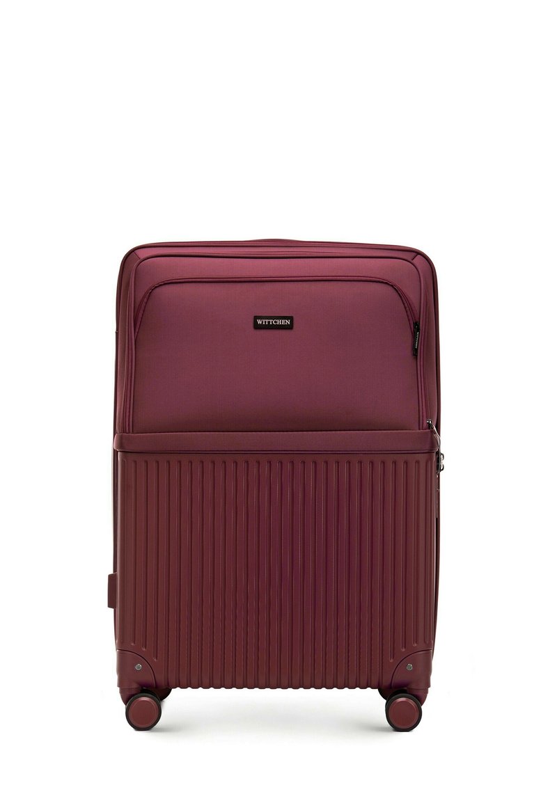 Valise debout bordeaux avec des rainures texturées, deux roues et une poignée supérieure. Elle comprend une poche avant zippée et une plaque de logo de la marque.