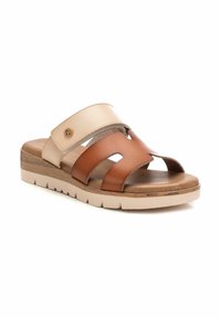 Sandalias de cuero marrón y beige con tres tiras recortadas, plantilla acolchada y una suela blanca resistente. Accento en dorado en la tira.