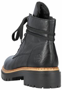 Black leather ankle boot featuring a textured finish, round toe, lace closure, and a rugged rubber sole with a contrasting tan stitching detail.