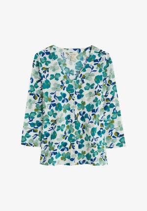 Bunte Blumenshirt mit V-Ausschnitt, 3/4-Ärmeln und Knopfverschluss. Der Stoff hat einen weißen Hintergrund mit blauen und grünen Blumenmustern.