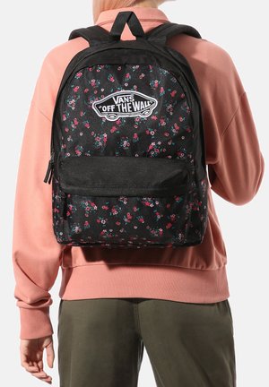 Sac à dos floral noir avec de petites fleurs roses et bleues, arborant un logo "Vans Off The Wall" bien visible et une poche zippée à l'avant pour le rangement.
