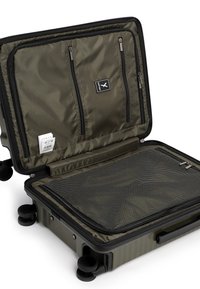 Valigia di dimensioni cabina di colore verde oliva con guscio rigido. Presenta due tasche esterne con zip, un compartimento in rete e ruote scorrevoli.