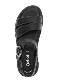 Black leather sandal featuring wide cross straps, a round metallic accent, and a textured rubber sole for grip. Brand name "Gabor" visible.