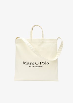 Cremfarbener Shopper mit zwei Griffen und einem Schulterriemen, versehen mit dem schwarzen Schriftzug "Marc O’Polo EST. IN STOCKHOLM".