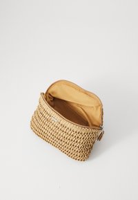 Woven straw pouch with a beige exterior, zip closure, and a smooth, tan interior. Features a small pocket inside for organization.