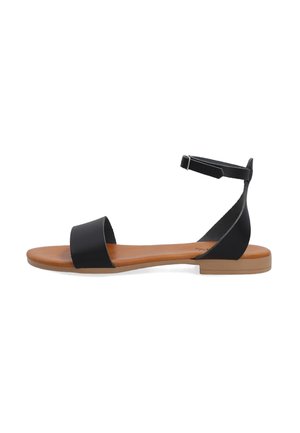 Black sandal with a flat sole, featuring a wide front strap and a narrow ankle strap secured with a metal buckle. Brown insole.
