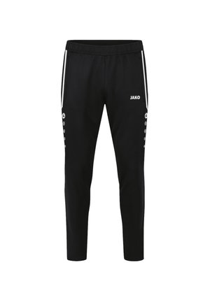 Pantalons de jogging noirs en tissu sportif avec un design fuselé, une taille élastique, des bandes blanches sur les côtés et des accents en boutons le long des coutures extérieures. Logo de la marque visible.