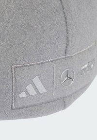 Gray felt baseball cap featuring embroidered Adidas and Mercedes logos in silver. Rounded shape with a structured, textured surface.