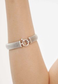 Pulsera de malla de plata con cierre redondo, que presenta un diseño texturizado con un acabado suave y detalle grabado en el cierre.