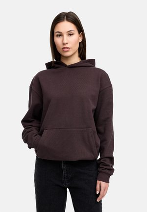 Dark purple hooded sweatshirt with a front pocket, loose fit, and ribbed cuffs, paired with black jeans. Smooth texture.
