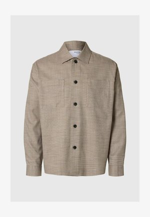 Bež kockast srajca s širšim ovratnikom, dolgimi rokavi, sprednjim gumbom in dvema žepoma na prsih. Ima črne gumbe.