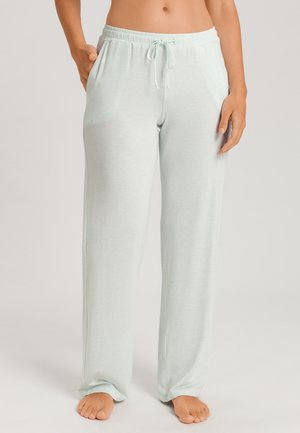 Pantalon de pyjama vert menthe clair en tissu doux et extensible. Il dispose d'une taille élastique avec cordon de serrage et de poches latérales. Coupe ample.
