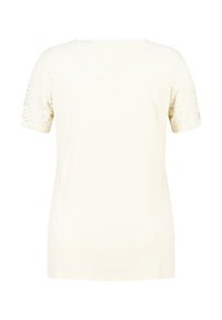 Crème kortekorte mouwen t-shirt met een ribbelstructuur, voorzien van kantdetails op de schouders en een gladde rug. Eenvoudig, klassiek ontwerp.