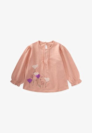 Svetlo roza dolgi rokavi top, narejen iz mehkega materiala, z vezenimi cvetovi v beli in vijolični barvi ter nabranimi detajli in zapiranjem na hrbtu.