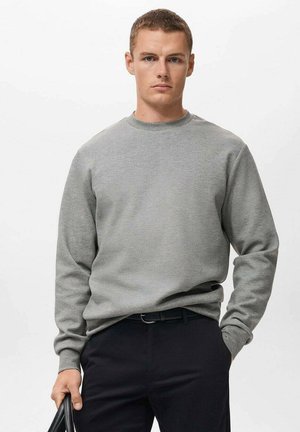 Gray crewneck sweatshirt made of soft fabric, featuring long sleeves and a relaxed fit, paired with black trousers. Simple and functional design.