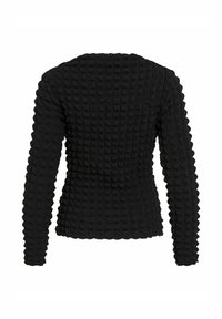 Maglione nero texture con un motivo a blocchi tridimensionale, maniche lunghe e una silhouette aderente. Tessuto liscio con una finitura leggermente rialzata.