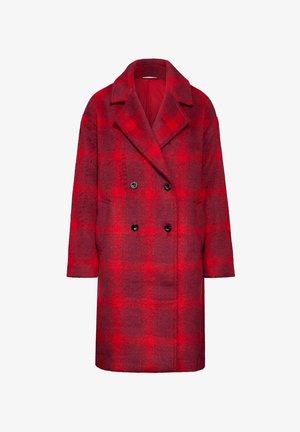 Czerwona i ciemnoczerwona w kropki wełniana kurtka, dwurzędowa z czarnymi guzikami, z dużymi klapami i bocznymi kieszeniami. Średniej długości i luźny krój.