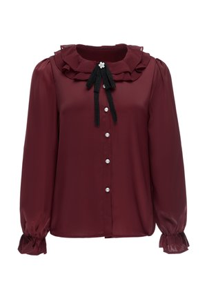 Bordeauxbluse med lange ærmer, flæset krave, perleknapper ned foran og sort båndsløjfe med blomst detalje ved halsudskæringen.