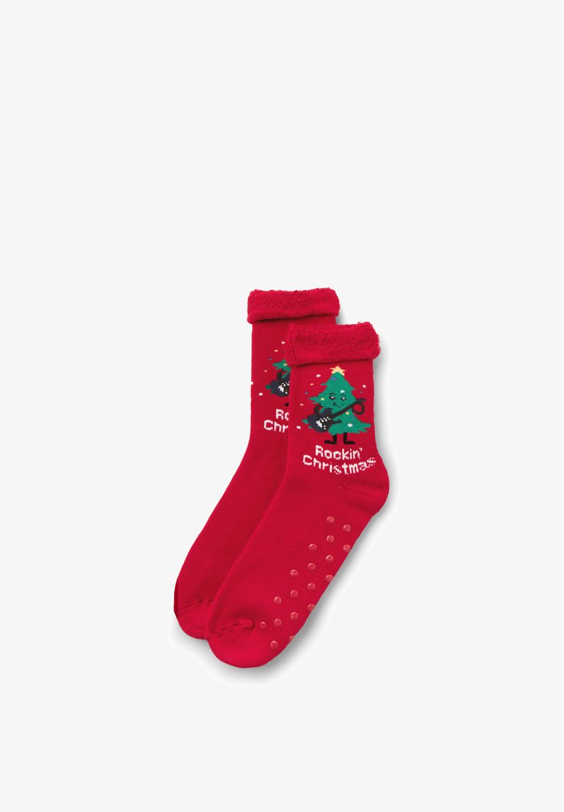 Chaussettes de Noël rouges avec un sapin de Noël chantant jouant de la guitare et le texte "Noël Rock'n'Roll", avec des grips antidérapants sur les semelles.