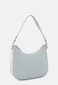 Sininen nahkainen olkalaukku, jolla on kaareva muoto, kultaiset metalliosat ja vetoketjulla suljettava kansi. Suora pinta ja minimalistinen muotoilu.