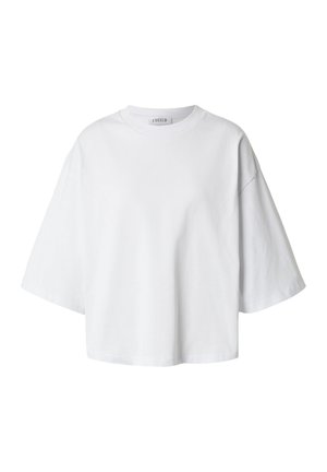 T-shirt blanc oversize à manches courtes, col rond et coupe décontractée, présenté sur un fond uni.