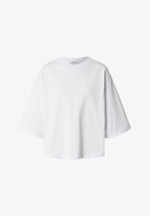 T-shirt blanc oversize à manches courtes, col rond et coupe décontractée, présenté sur un fond uni.