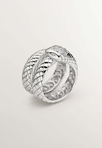 Anillo en forma de serpiente de plata con escamas texturizadas, diseño enroscado y una pequeña gema transparente en la cabeza de la serpiente.