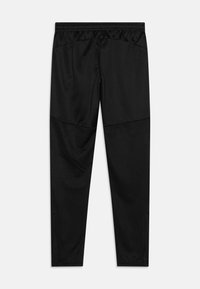 Zwarte sportbroeken met een gladde bovenkant van stof en een gestructureerde onderkant, voorzien van een elastische tailleband en een slim fit ontwerp.
