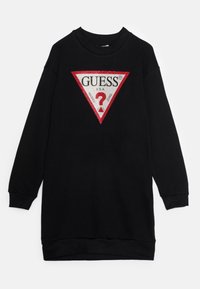 Svart sweatshirtklänning med en stor röd och vit triangel-logotyp med texten "GUESS?", tillverkad av mjukt material med ribbade ärmslut.